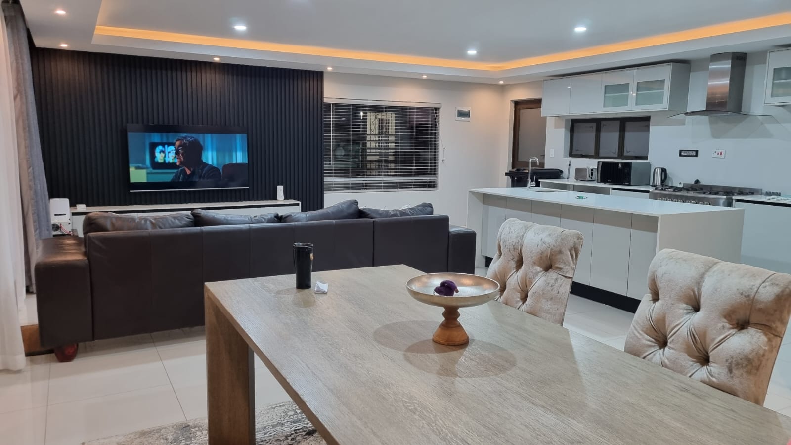Open-plan living and dining area at The Pecan villa, Bulawayo